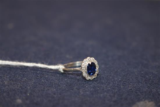 A mid 20th century white metal, synthetic sapphire? and diamond cluster dress ring, size O/P.